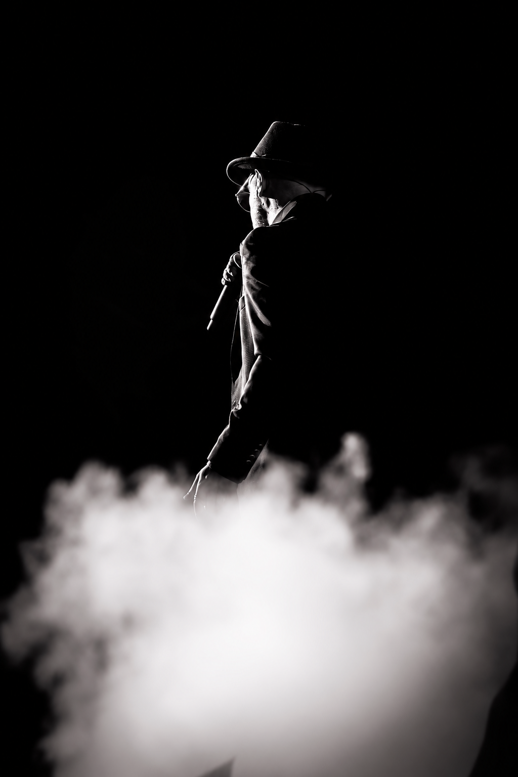Matthew James performing on stage, surrounded by smoke